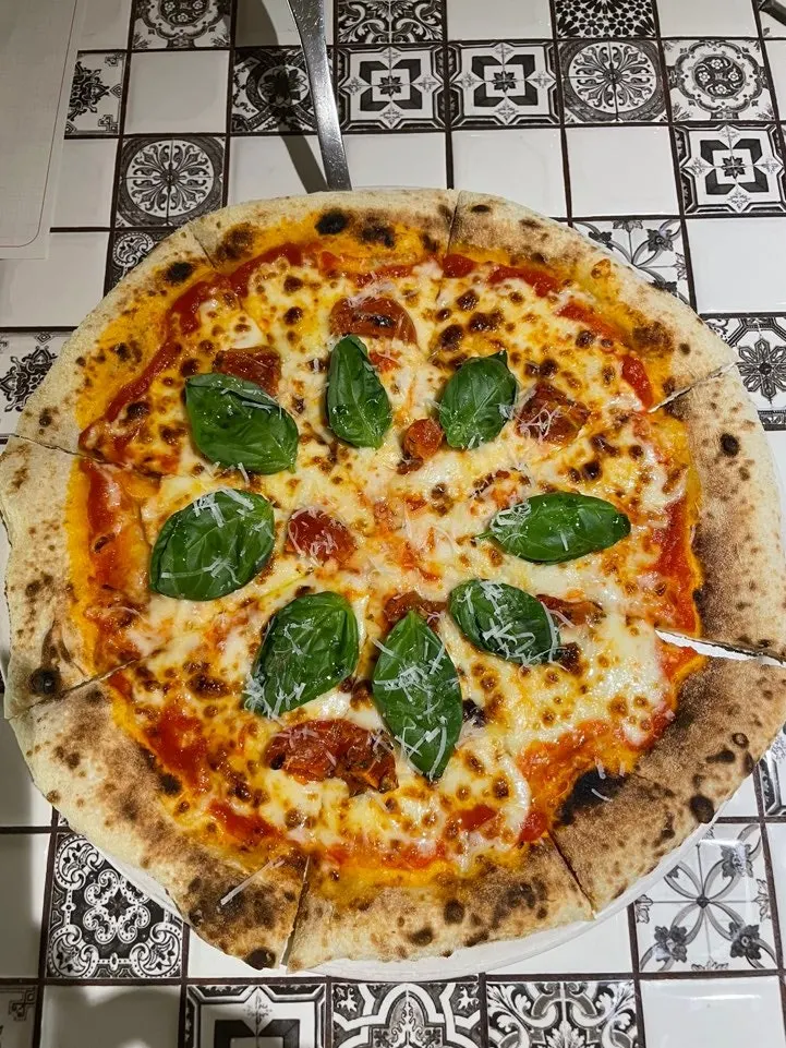 Margherita pizza fresh out of the wood oven