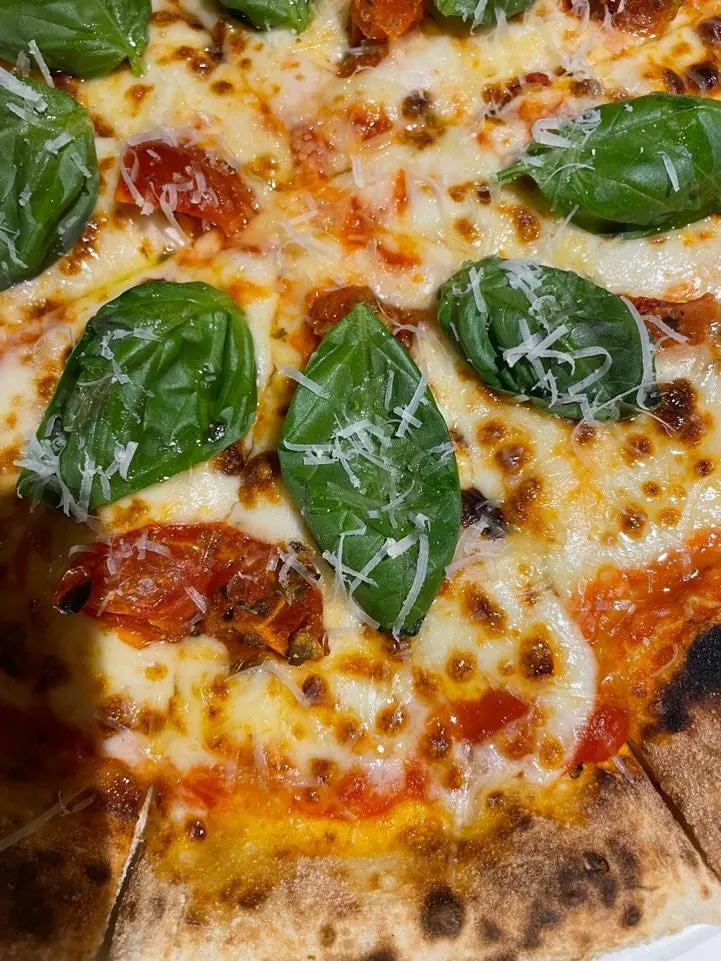 Margherita pizza piled with mozzarella cheese