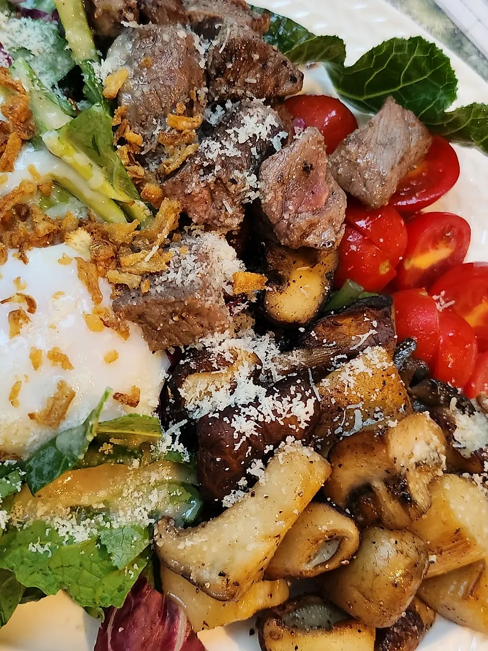 Close-up of thick beef cubes and sautéed mushrooms