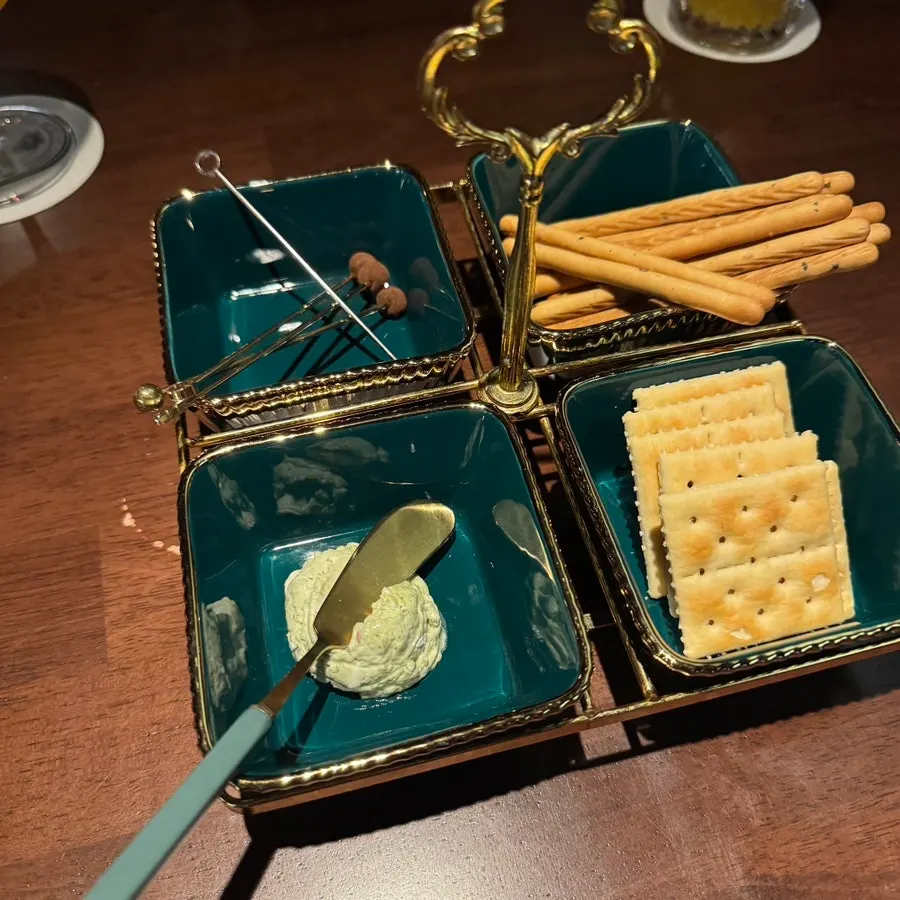 Starter snack plate with chocolate, crackers, and sesame sticks