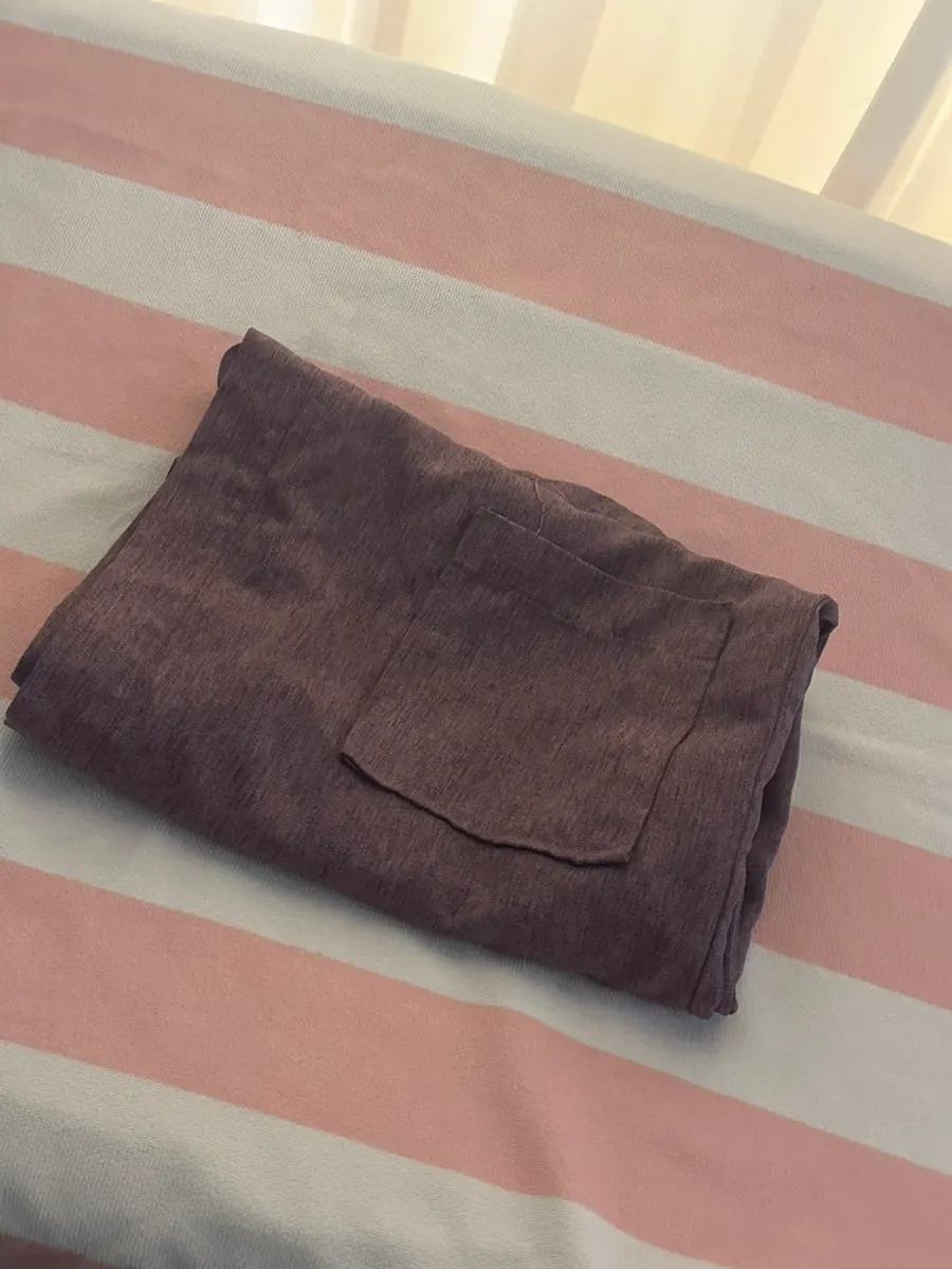 Changed into a robe after undressing, ready for treatment
