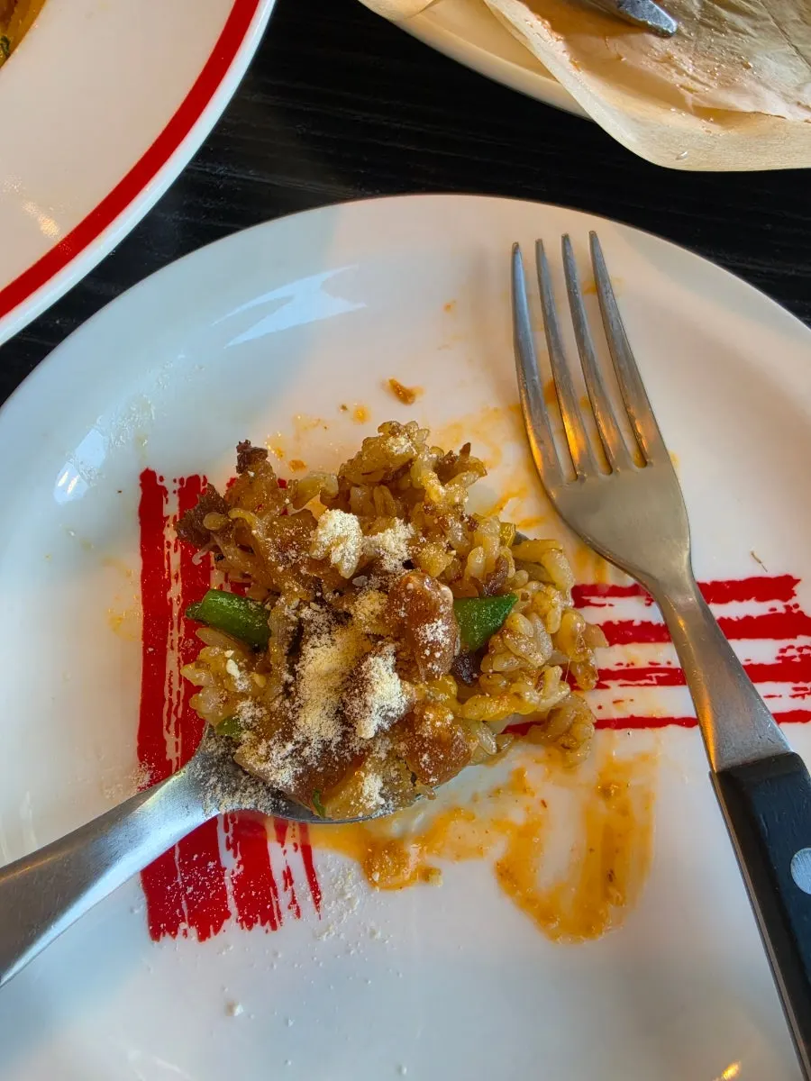 Spoonful of pilaf piled with beef belly and rice
