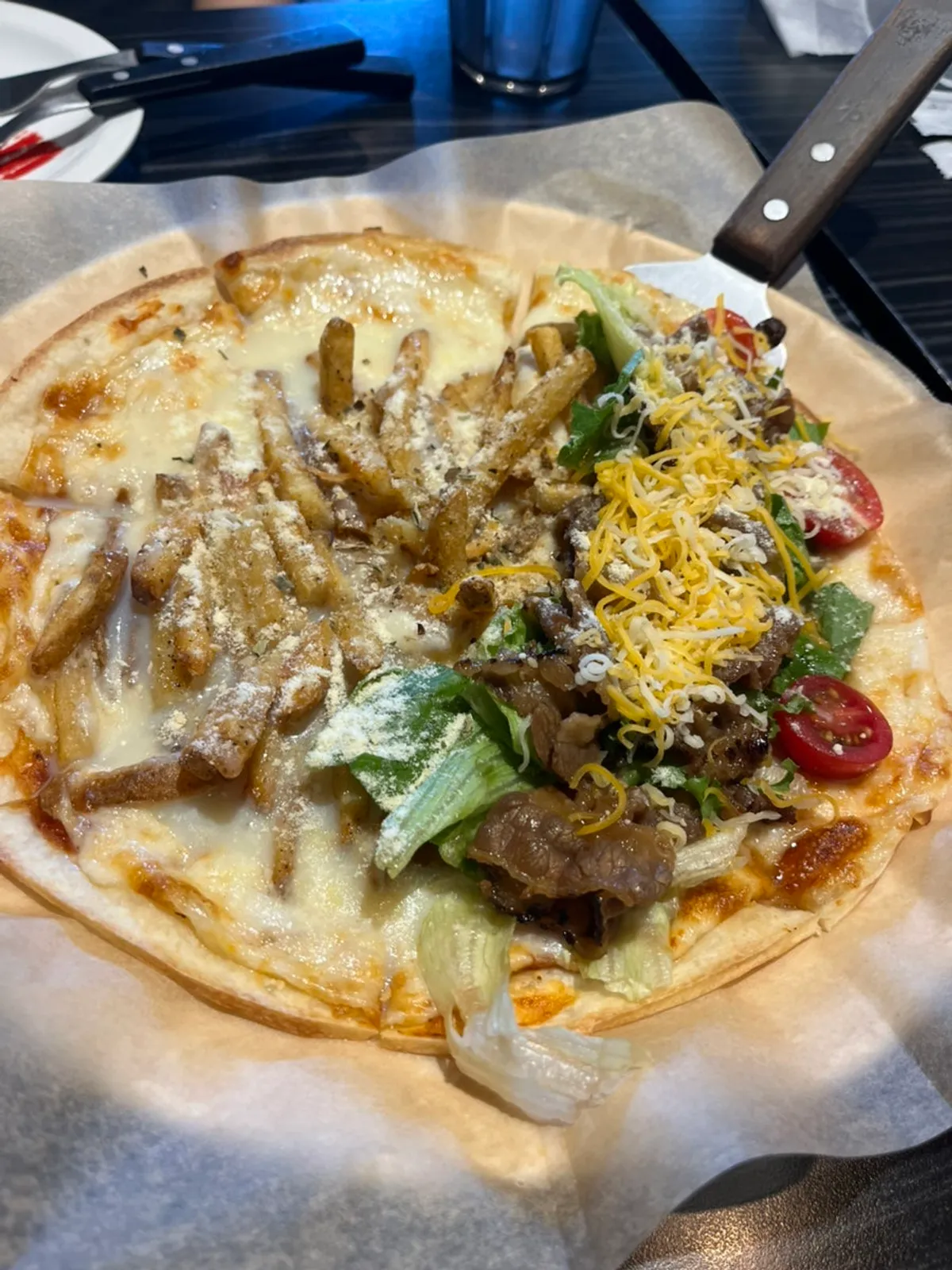 Bulgogi salad pizza topped with salad greens and bulgogi