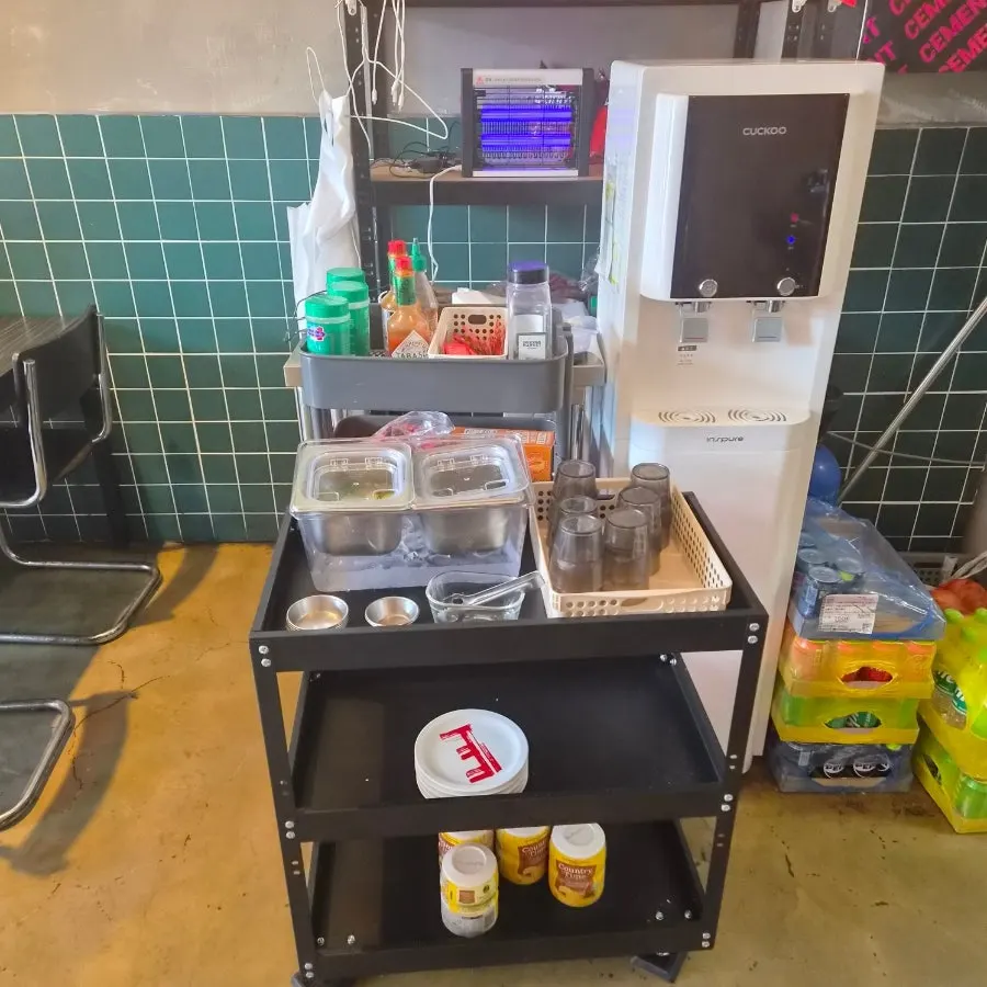 Self-serve corner with utensils and pickles