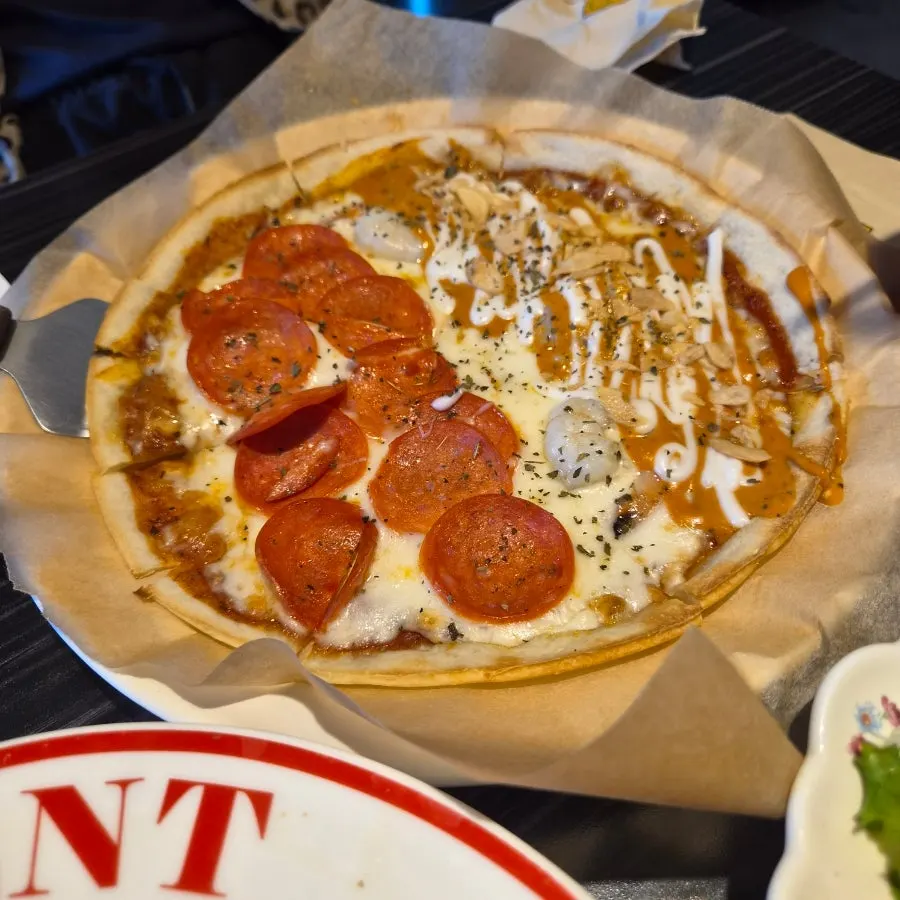 A whole half-and-half pepperoni and chipotle shrimp pizza