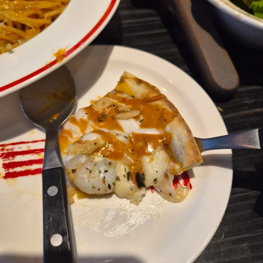 Close-up of a chipotle shrimp pizza slice