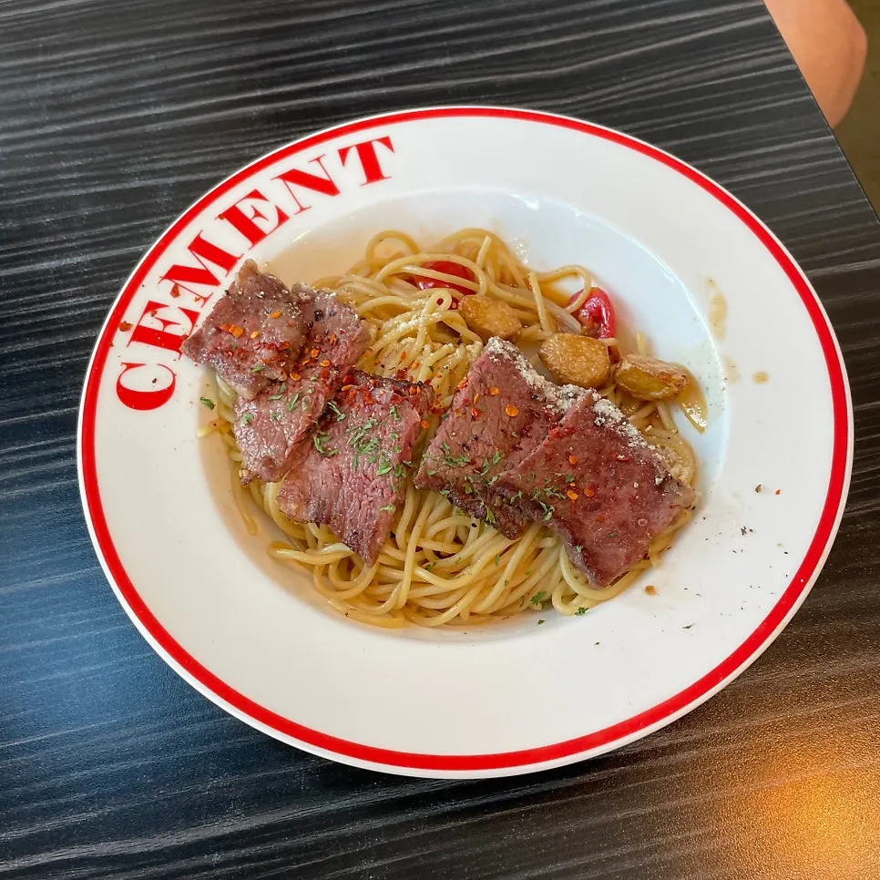 Salchi garlic oil pasta topped with chuck flap steak