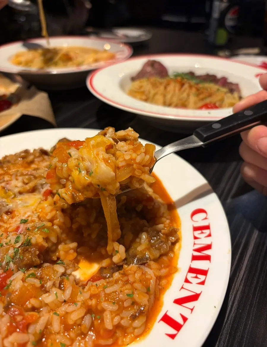 A spoonful of the spicy cream risotto with melted cheese