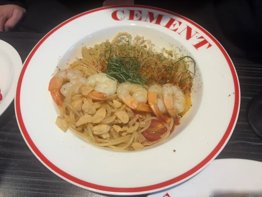 Both plates of shrimp oil pasta finished