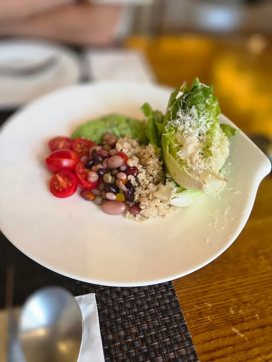 Close-up of salad with beans and avocado on top