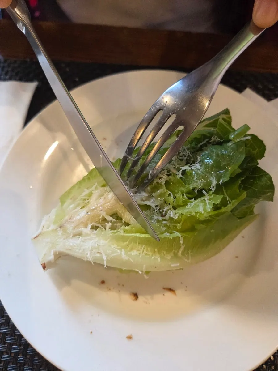 Salad topped with grilled romaine and cheese