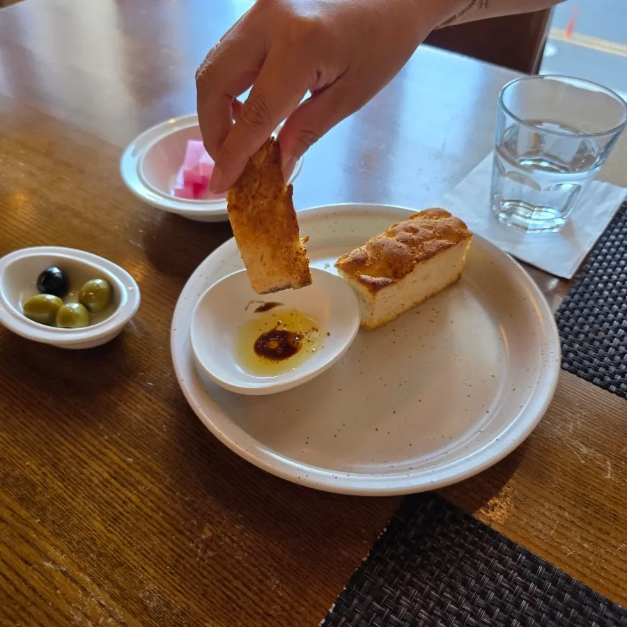 Pre-meal bread torn into a bite-sized piece