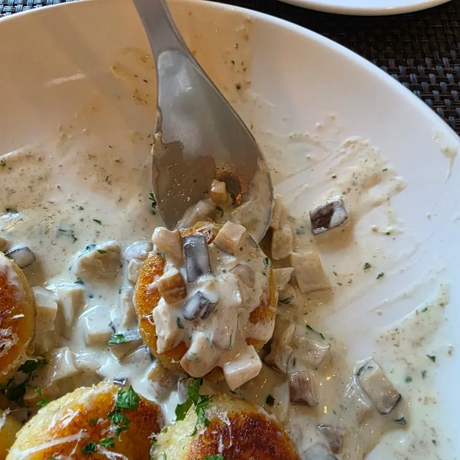 Close-up of roasted potato gnocchi with mushroom cream sauce