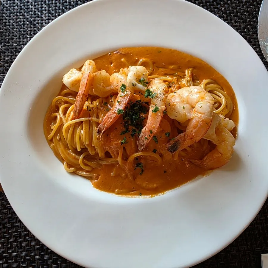 Shrimp rosé pasta topped with four large shrimp