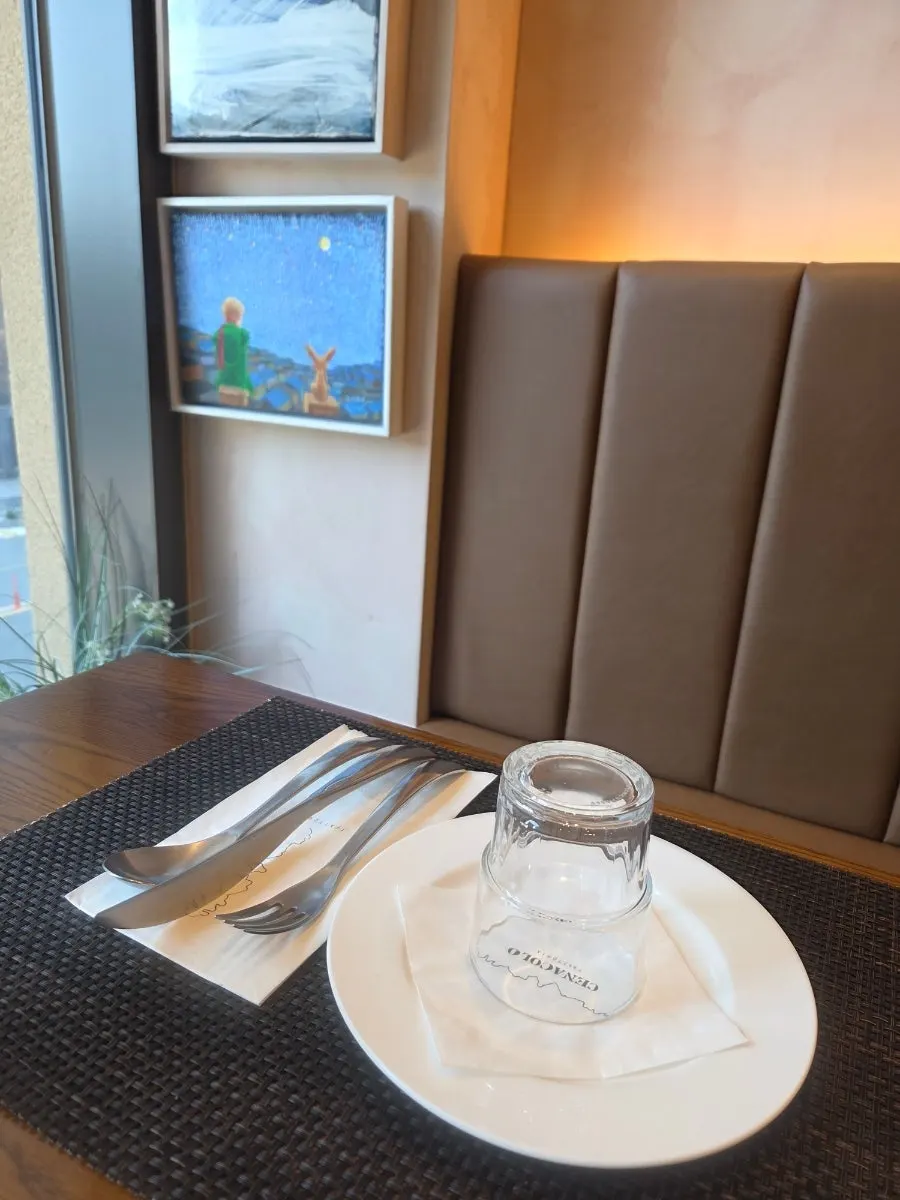 Table with a view of Artfore through the window