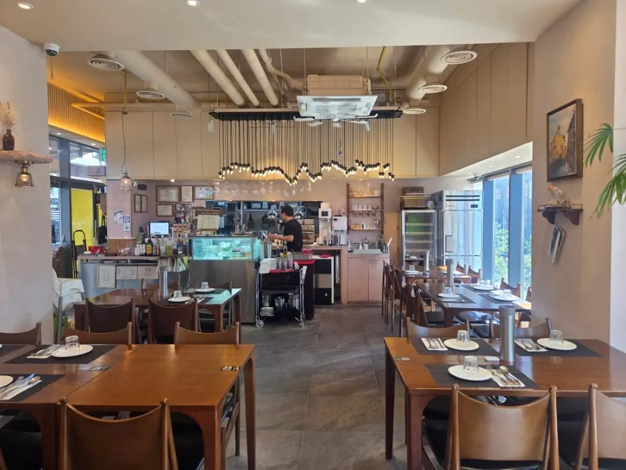 Open kitchen at Cenacolo with wine glasses hanging in a row