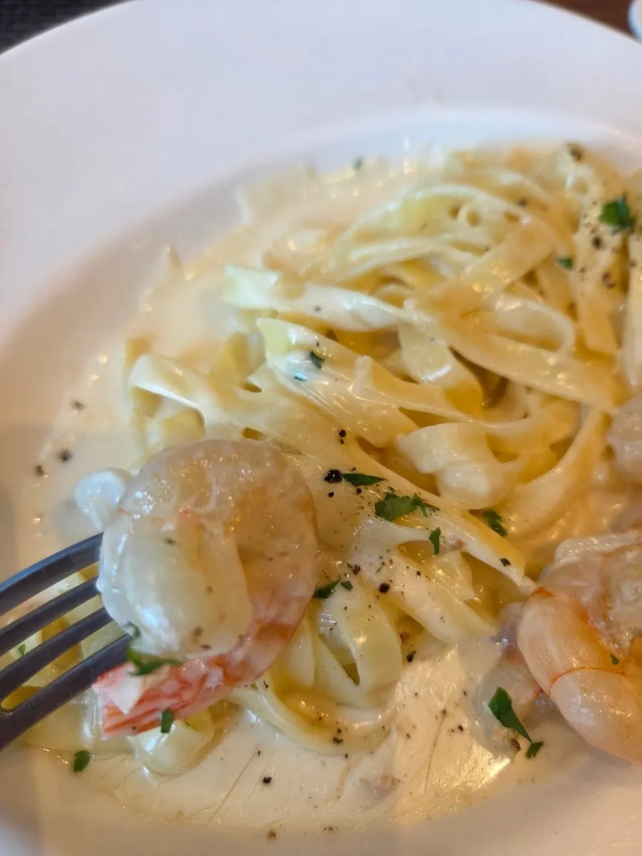 Flat tagliatelle and shrimp coated in cream sauce