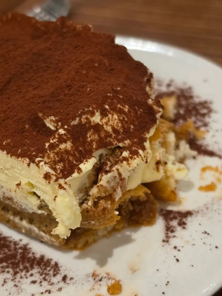 Center Coffee's coffee and tiramisu set beside a book