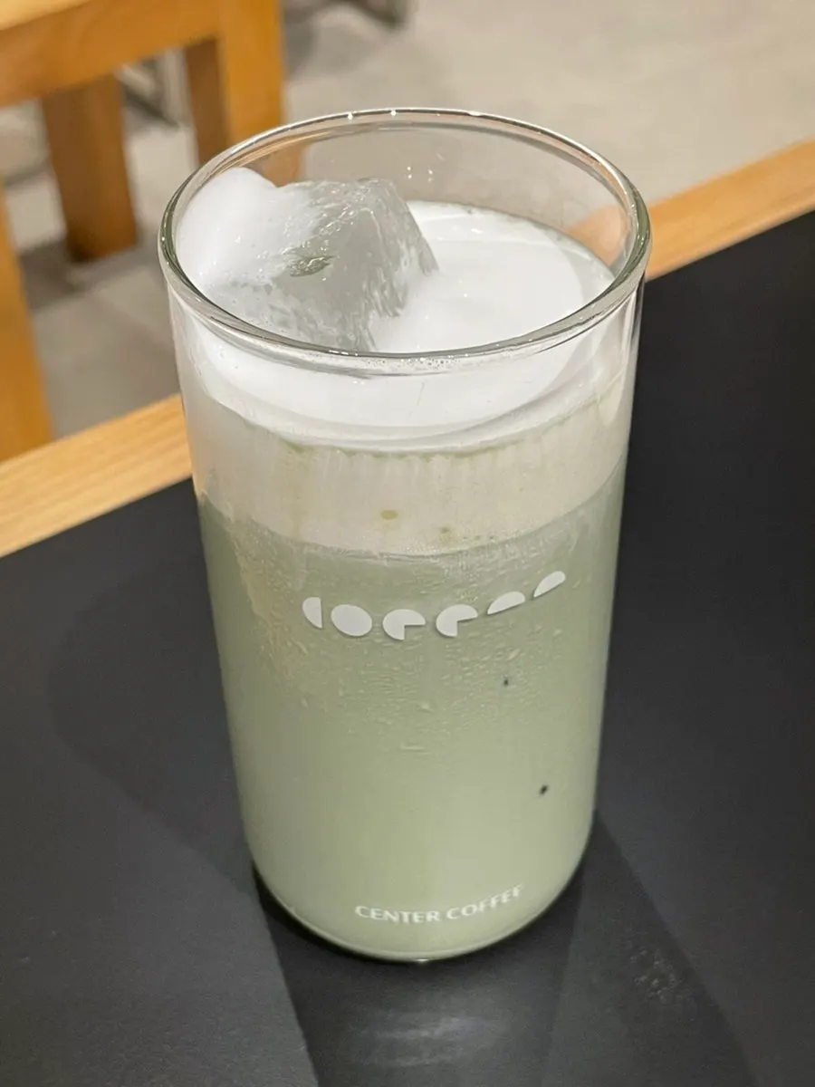 Iced mugwort latte topped with whipped cream