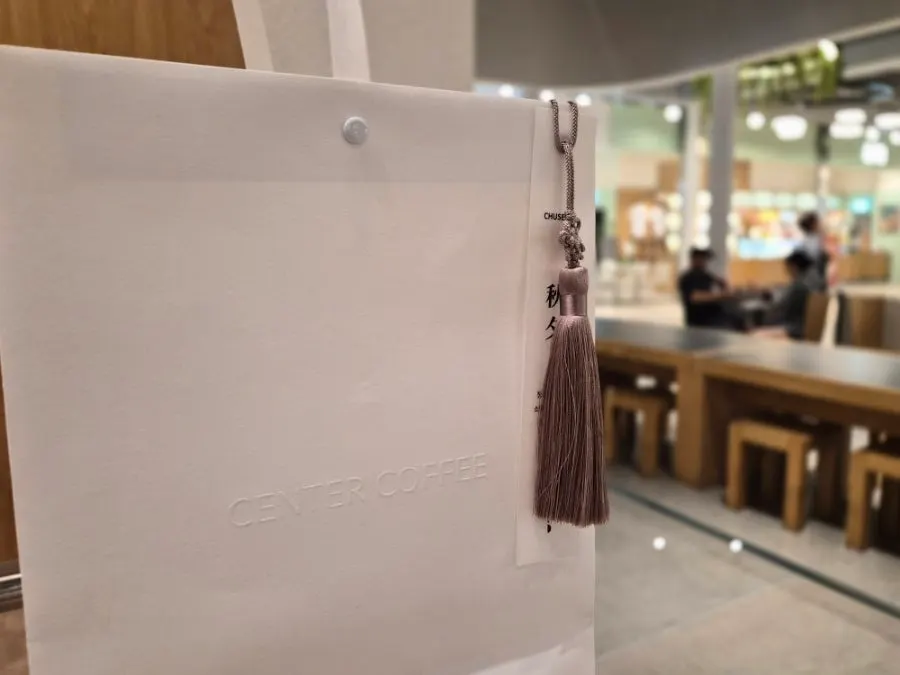 Gift shopping bag decorated with a norigae ornament