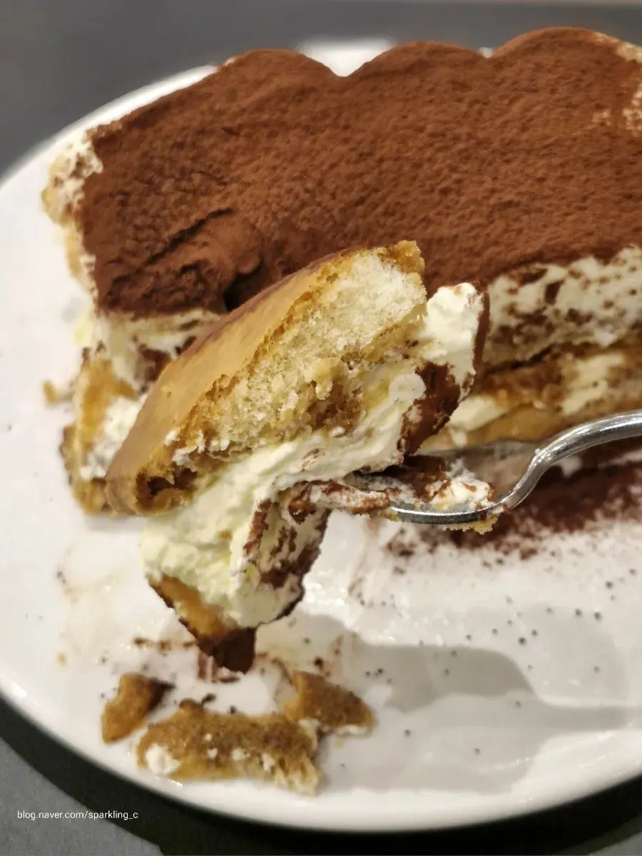 Cross-section of tiramisu showing ladyfingers and mascarpone cream