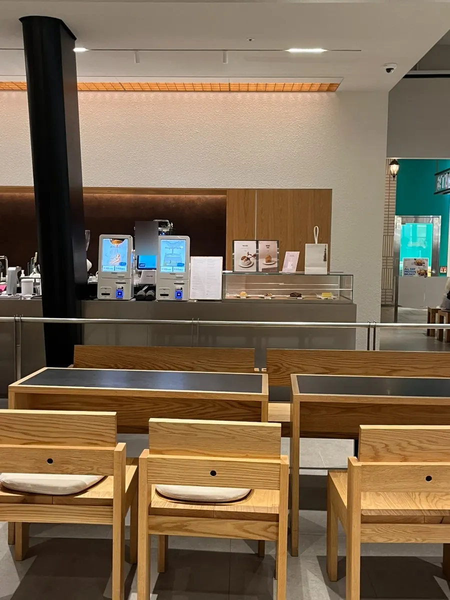 Café hall decorated with wood-toned furniture