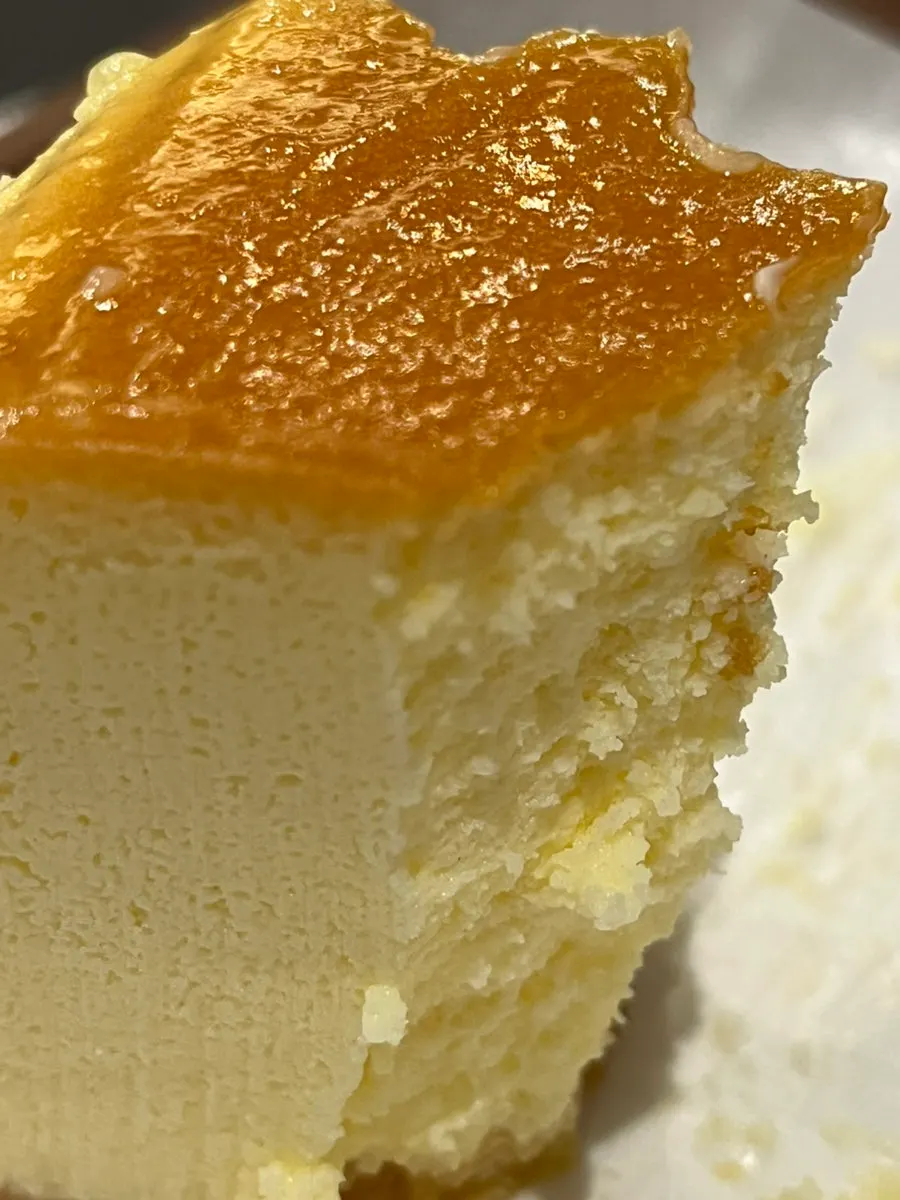 A slice of Chicago cheesecake on a plate