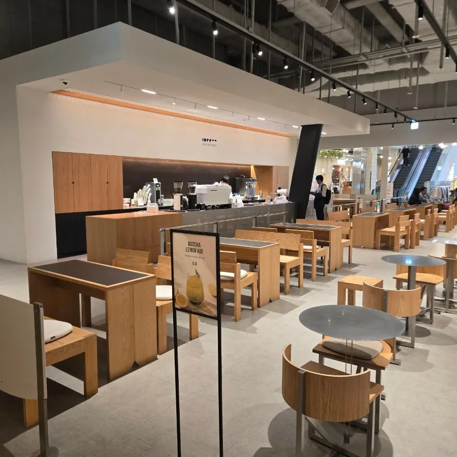 Café seating with wood-toned furniture mixed in