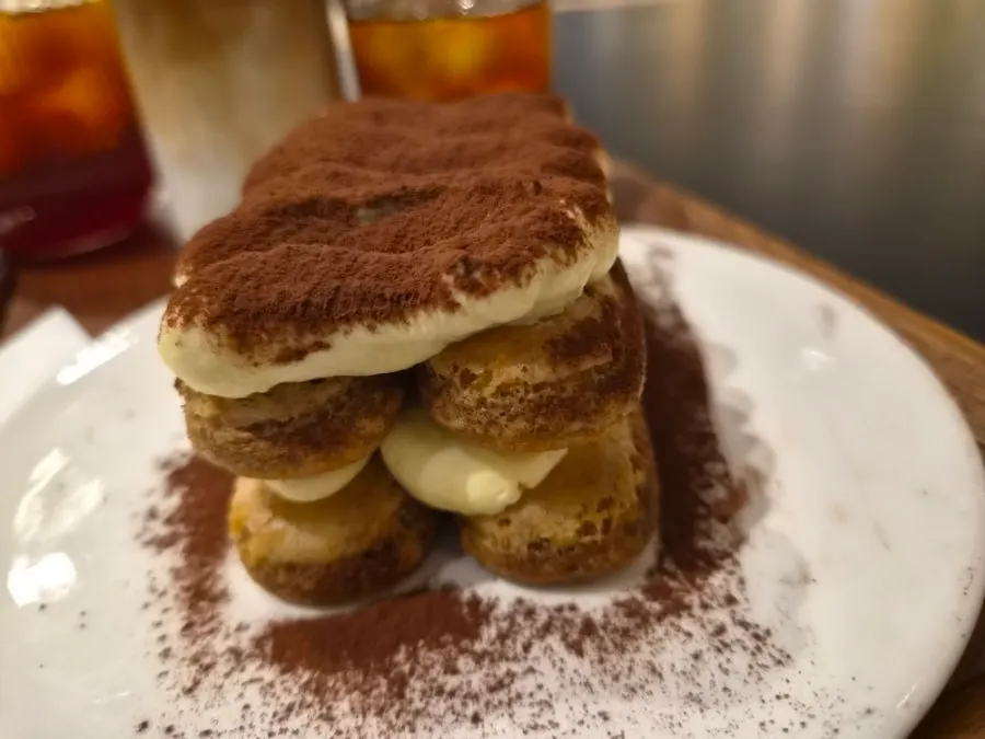 Cross-section of tiramisu lifted with a fork