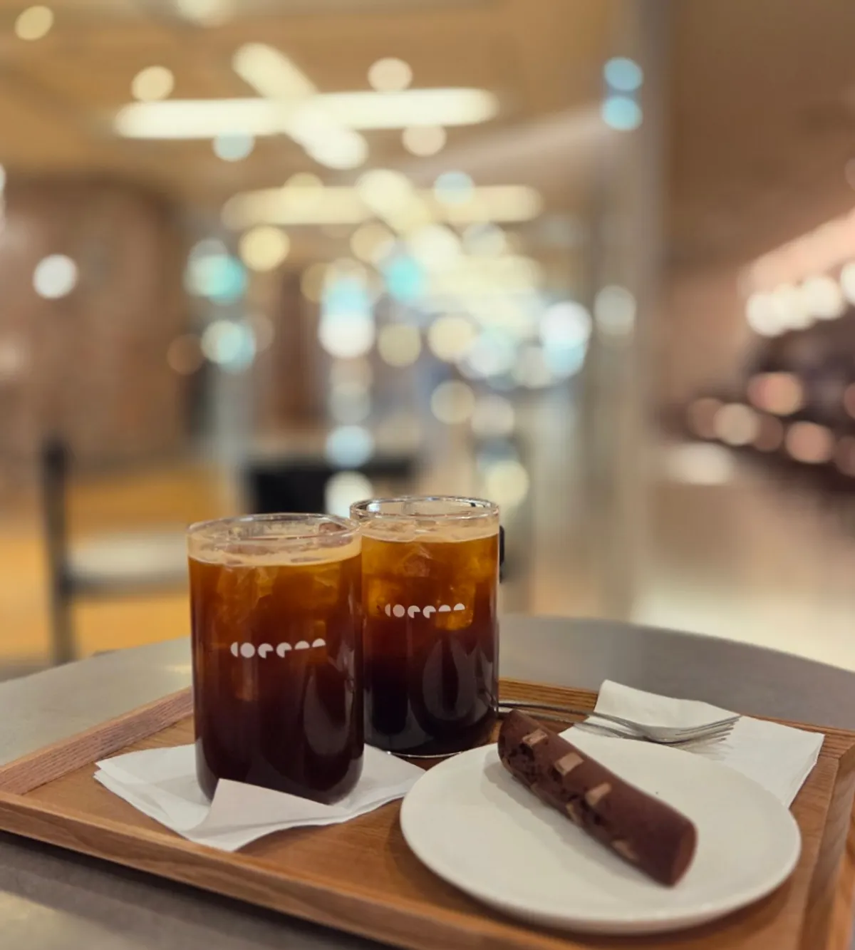 Iced americano and a slice of dark chocolate financier