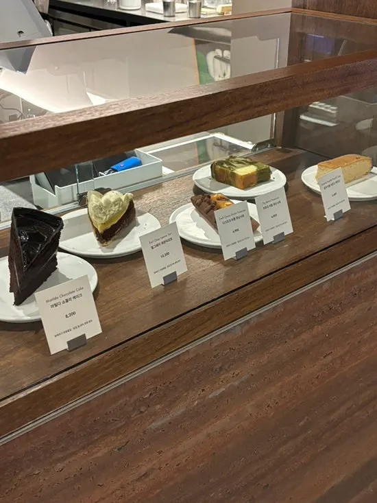Dessert display case with cakes and tarts