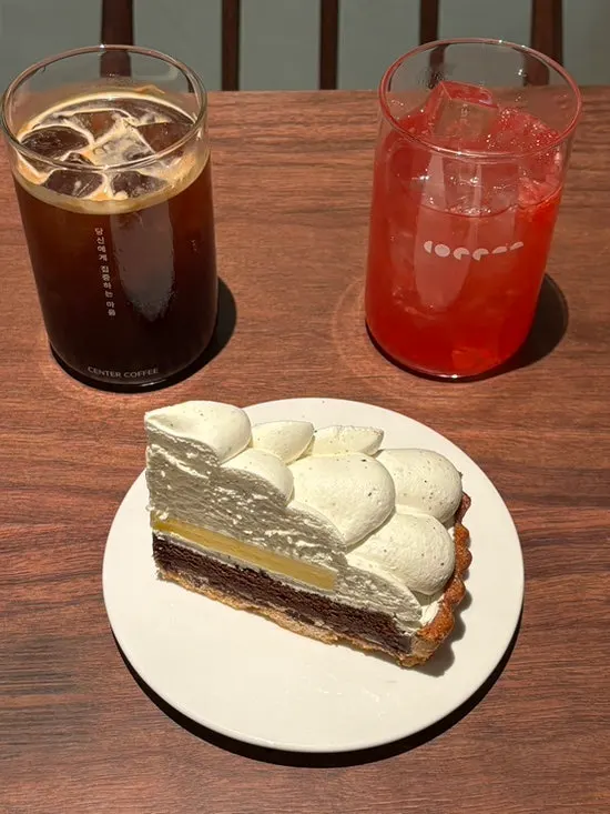Table setting with americano, red cordial, and Earl Grey lemon tart