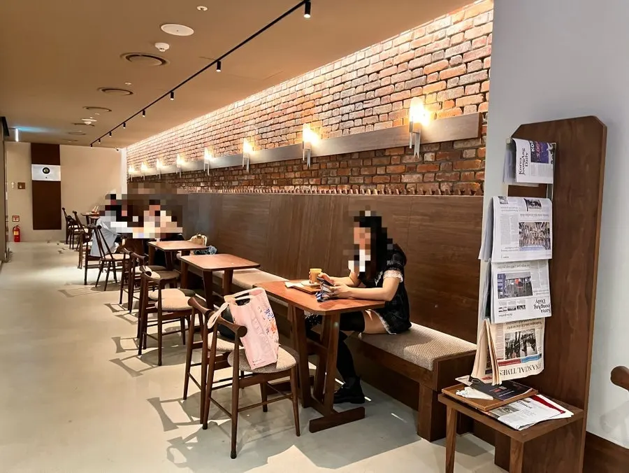 Interior of Center Coffee Gwanghwamun finished in wood tones and brick