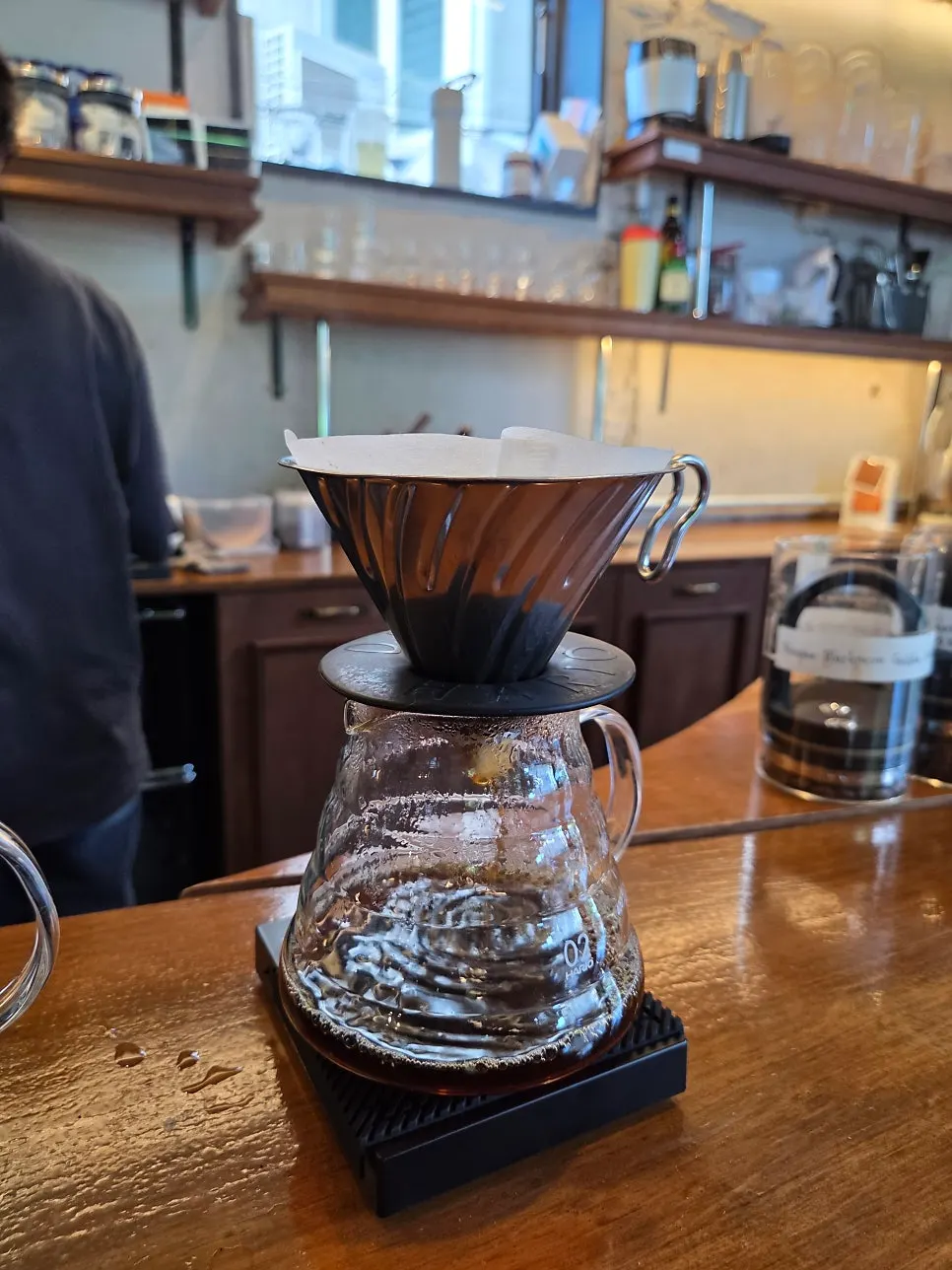 Hand-drip coffee beans being prepared after ordering
