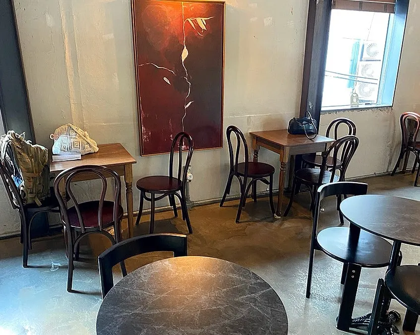 Two-seater tables with woody interior on the 2nd floor