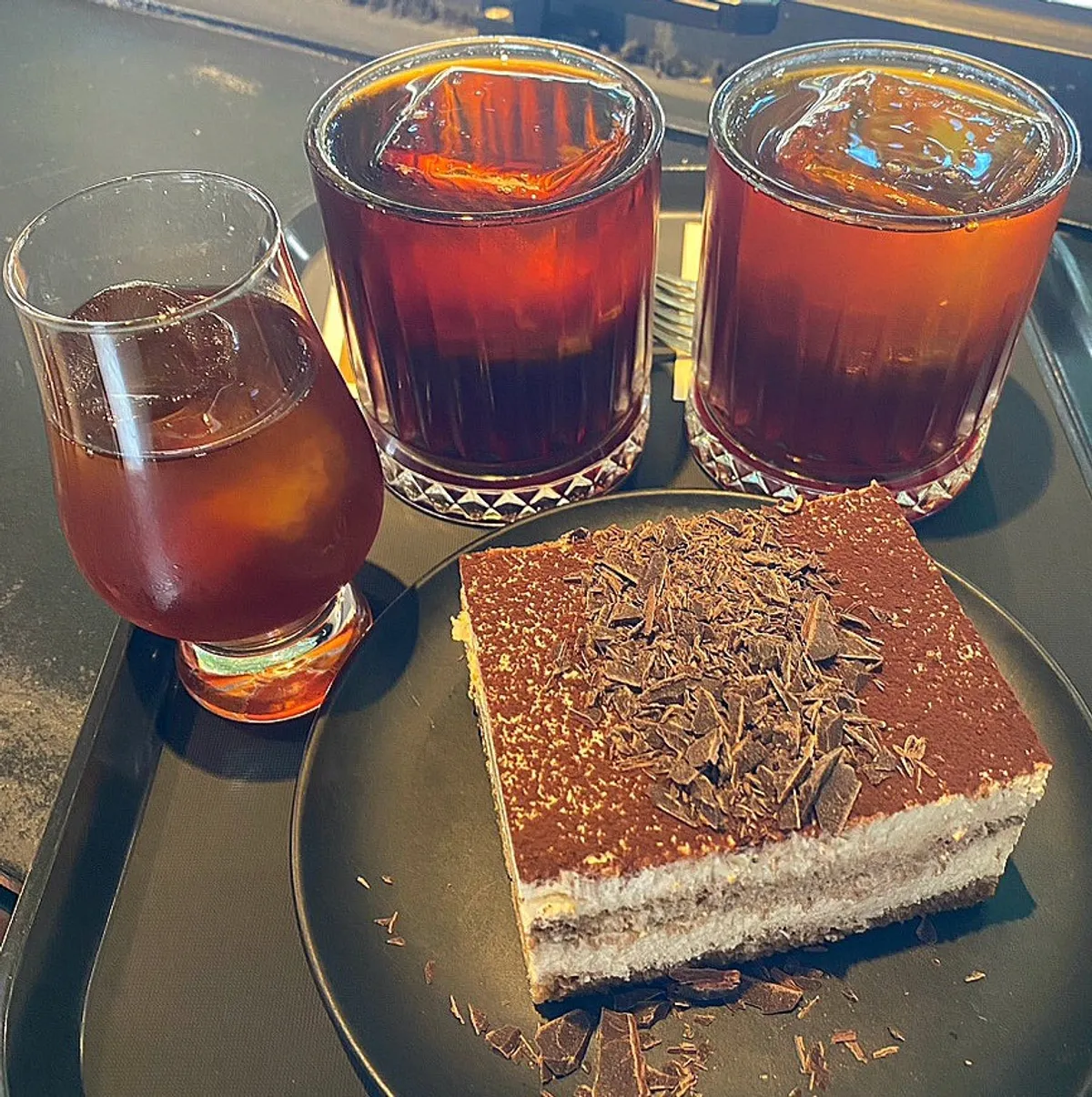 Two iced brewing coffees served with Classic Tiramisu