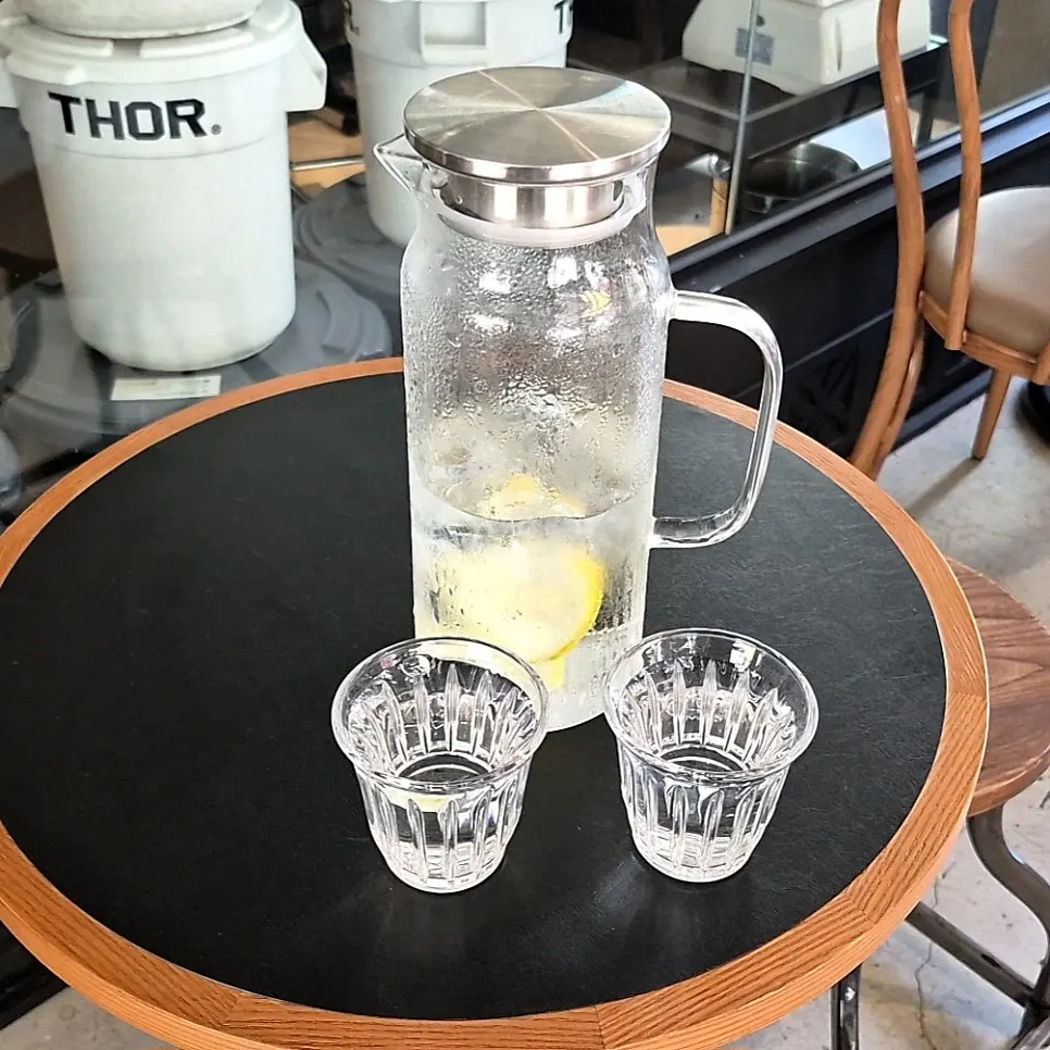 Lemon water and cups at the self-serve corner
