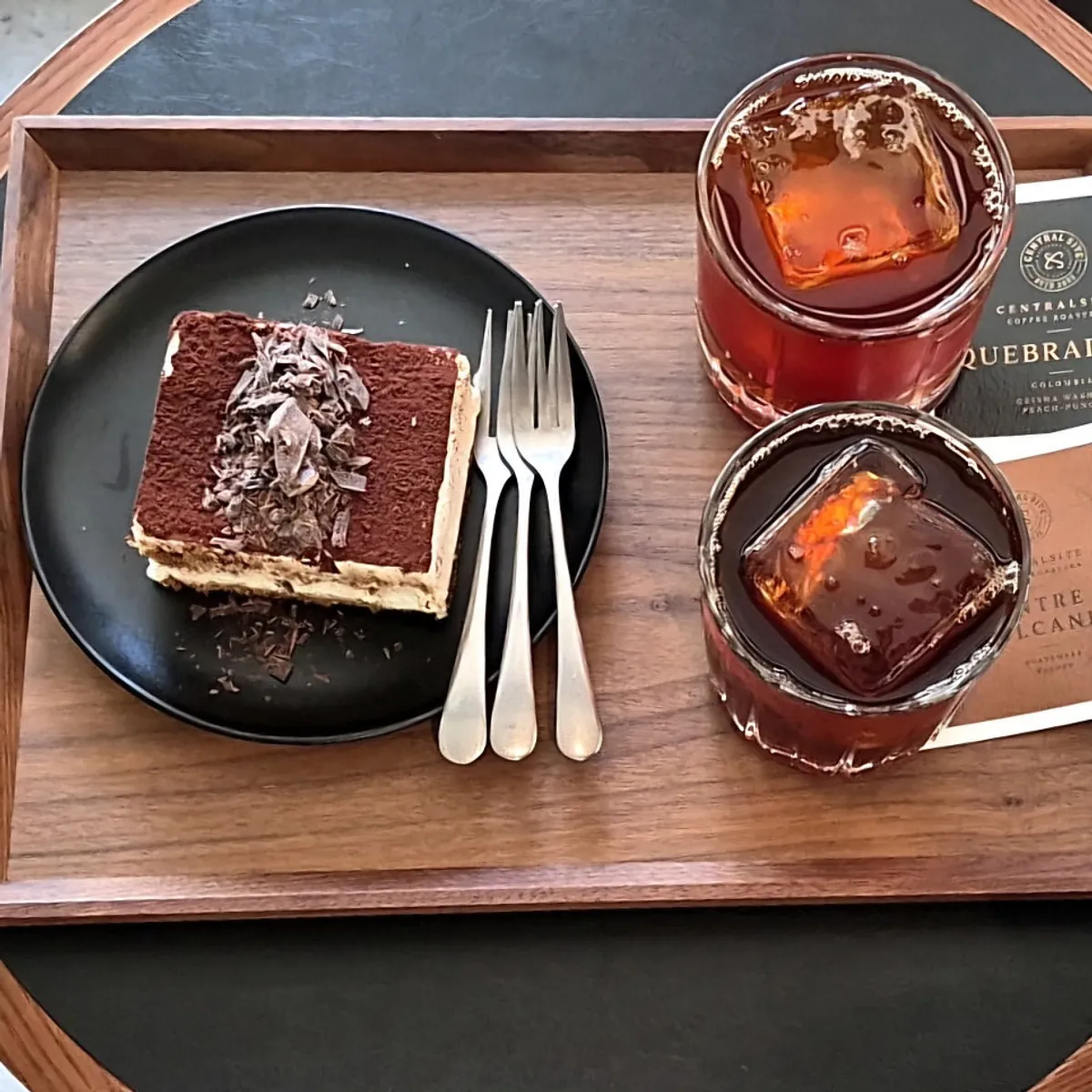 Classic tiramisu with two glasses of iced brewed coffee
