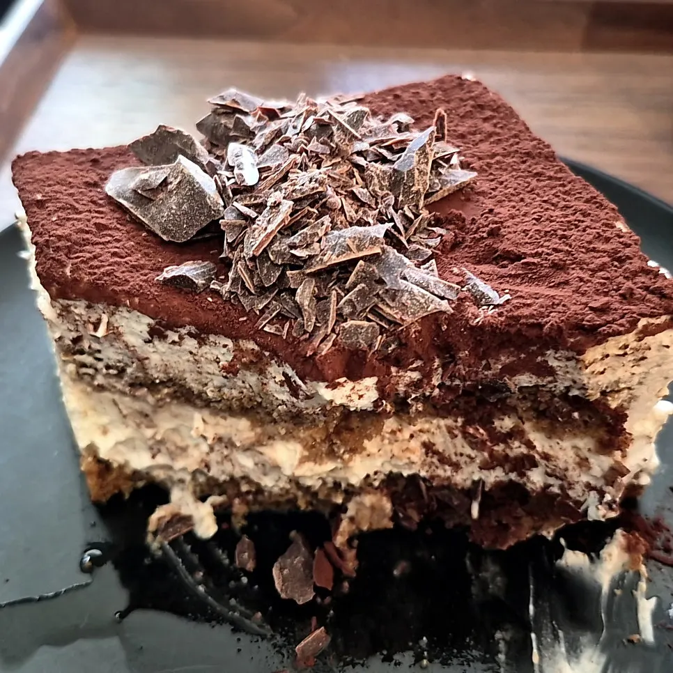 Cross-section of classic tiramisu scooped with a fork