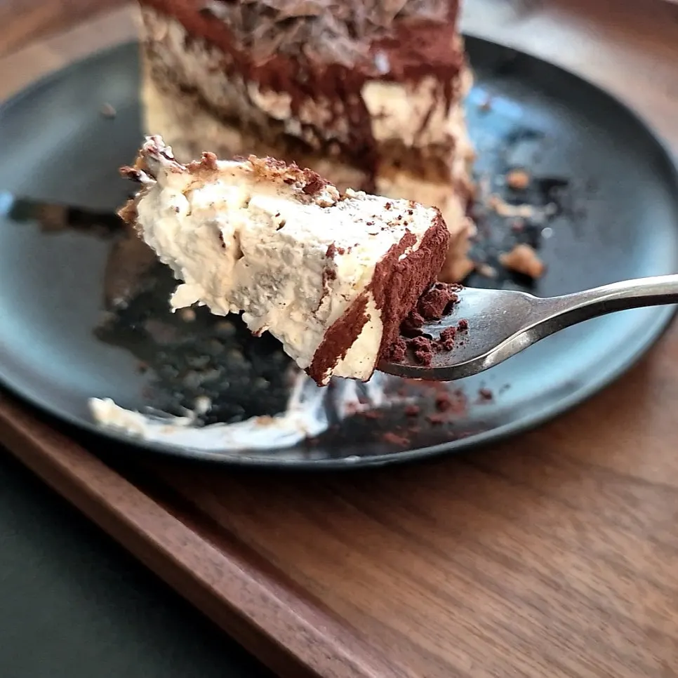 Classic tiramisu and coffee together on the table