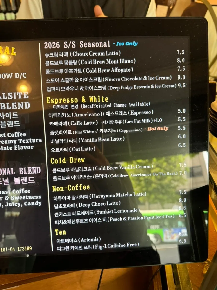 Menu board listing espresso drinks and desserts