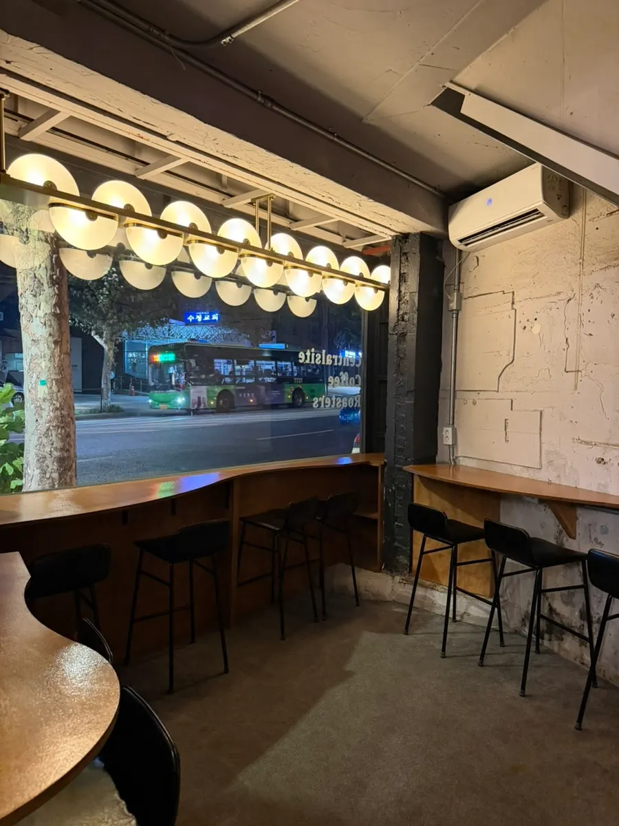 Window-facing table seating in front of the 1st-floor counter