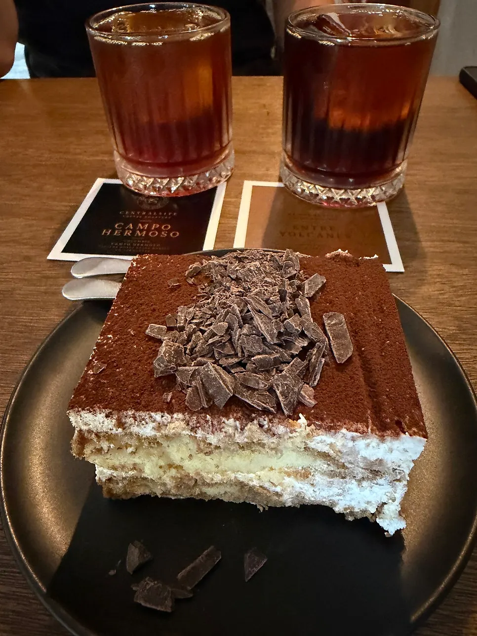 Classic tiramisu placed next to the coffee