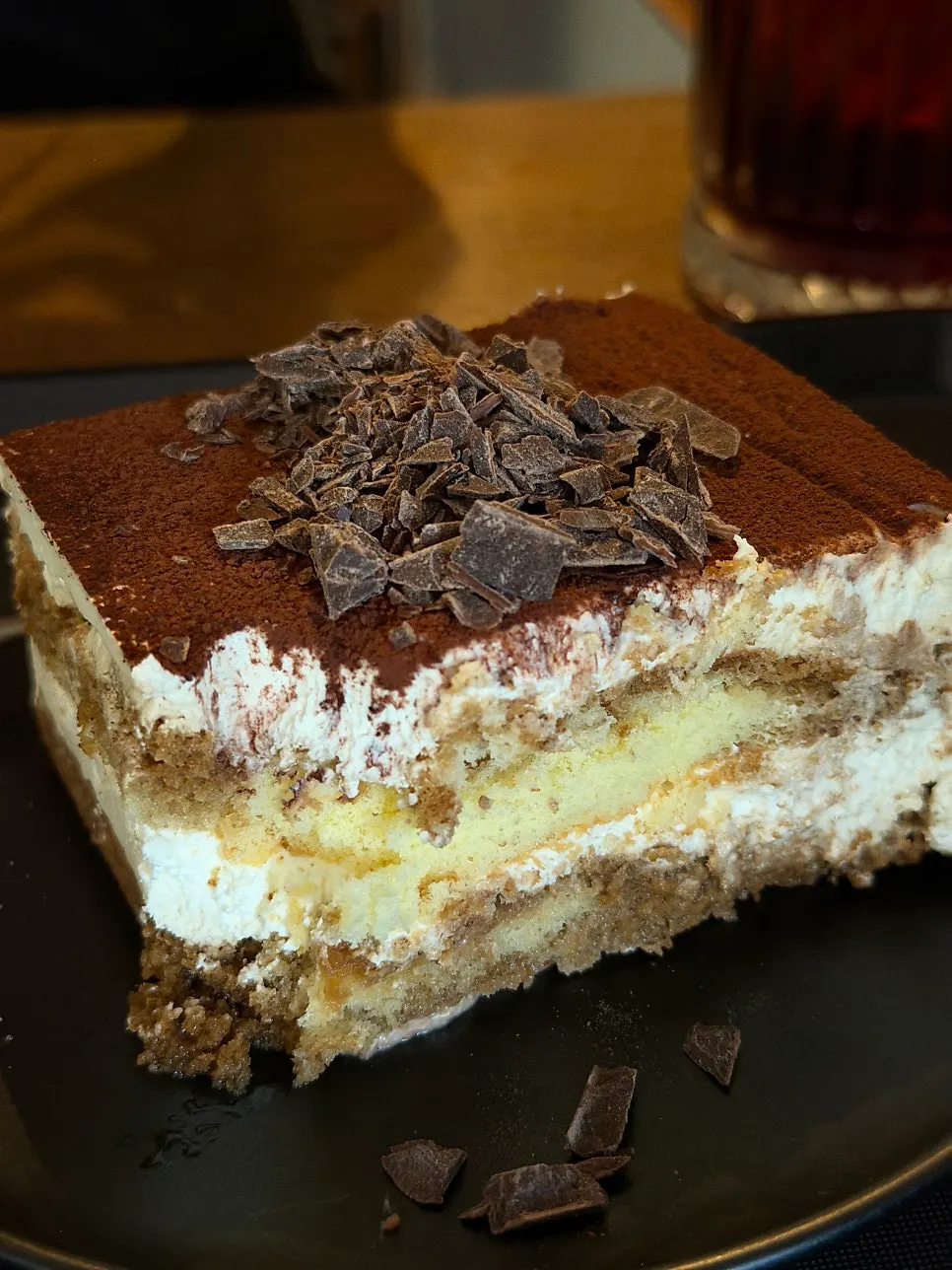 A spoonful of tiramisu showing the cream and sponge layers