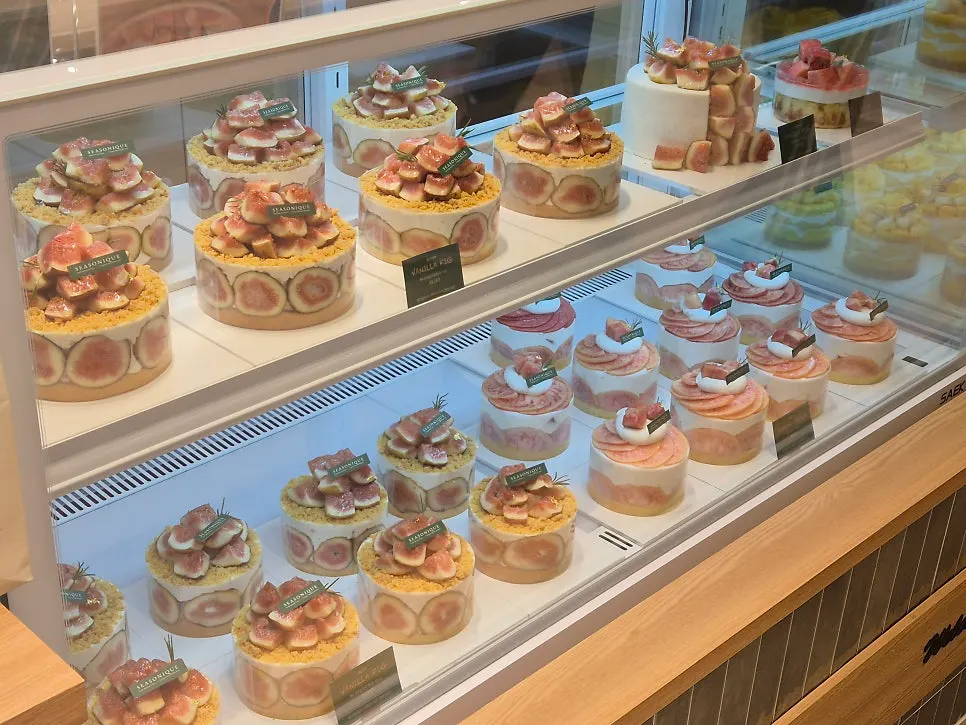 Mango, fig, and peach seasonal fruit cakes on display