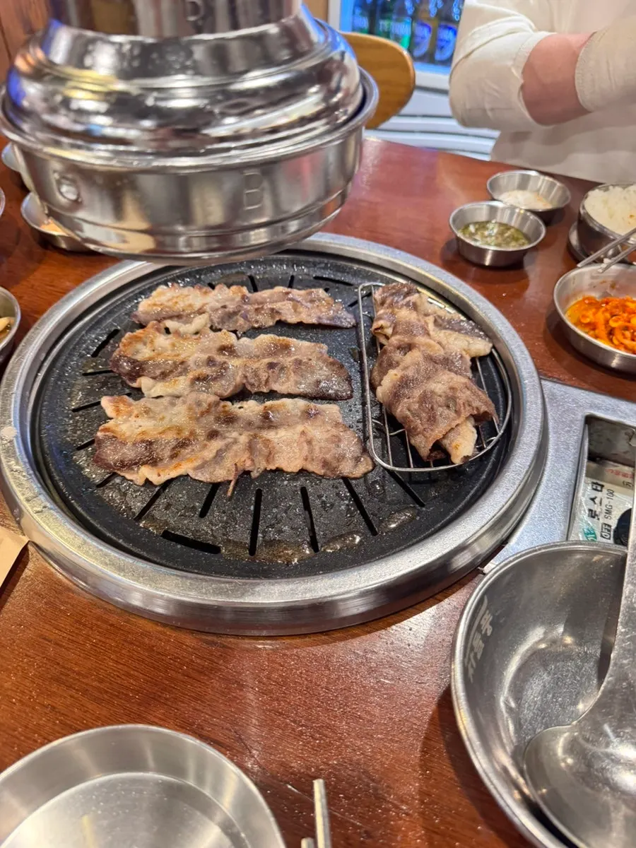 Table spread with doenjang jjigae and meat