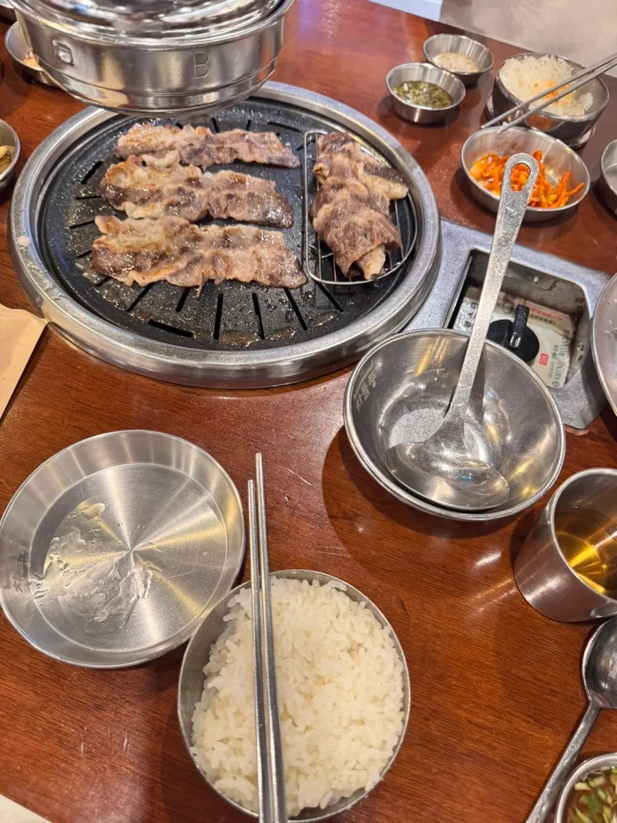Rice, doenjang jjigae, and woo samgyeop laid out together