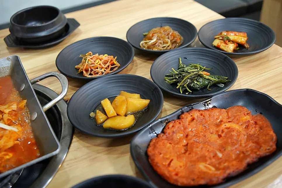 Korean table spread with various side dishes