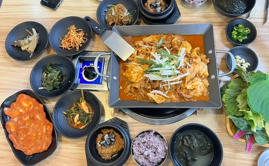 Pork ssam bap table loaded with basic side dishes