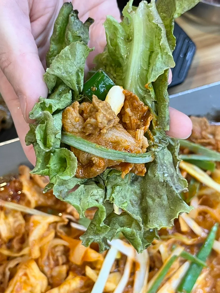 A finished pork wrap topped with garlic
